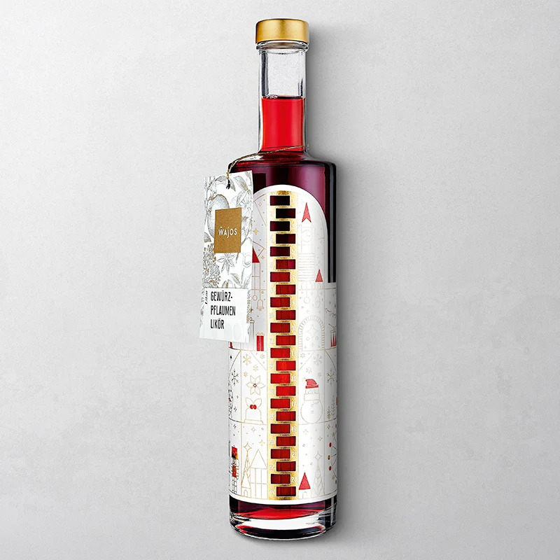 Wajos Adventskalender Flasche - gefüllt mit Gewürzpflaumen Likör