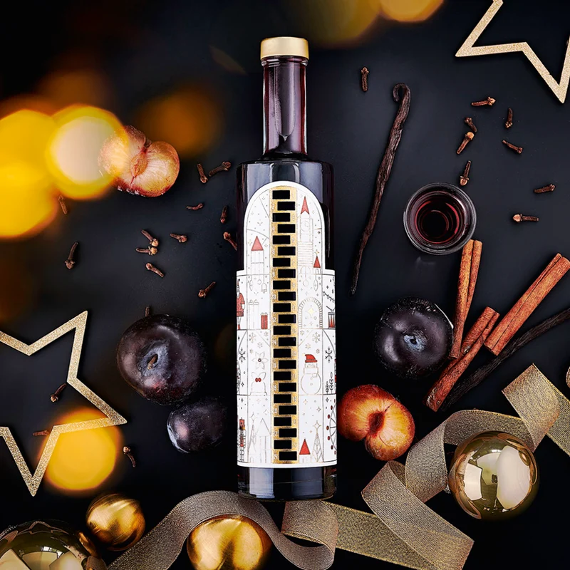 Wajos Adventskalender Flasche - gefüllt mit Gewürzpflaumen Likör