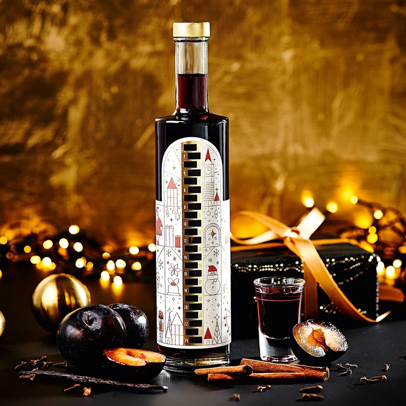 Wajos Adventskalender Flasche - gefüllt mit Gewürzpflaumen Likör